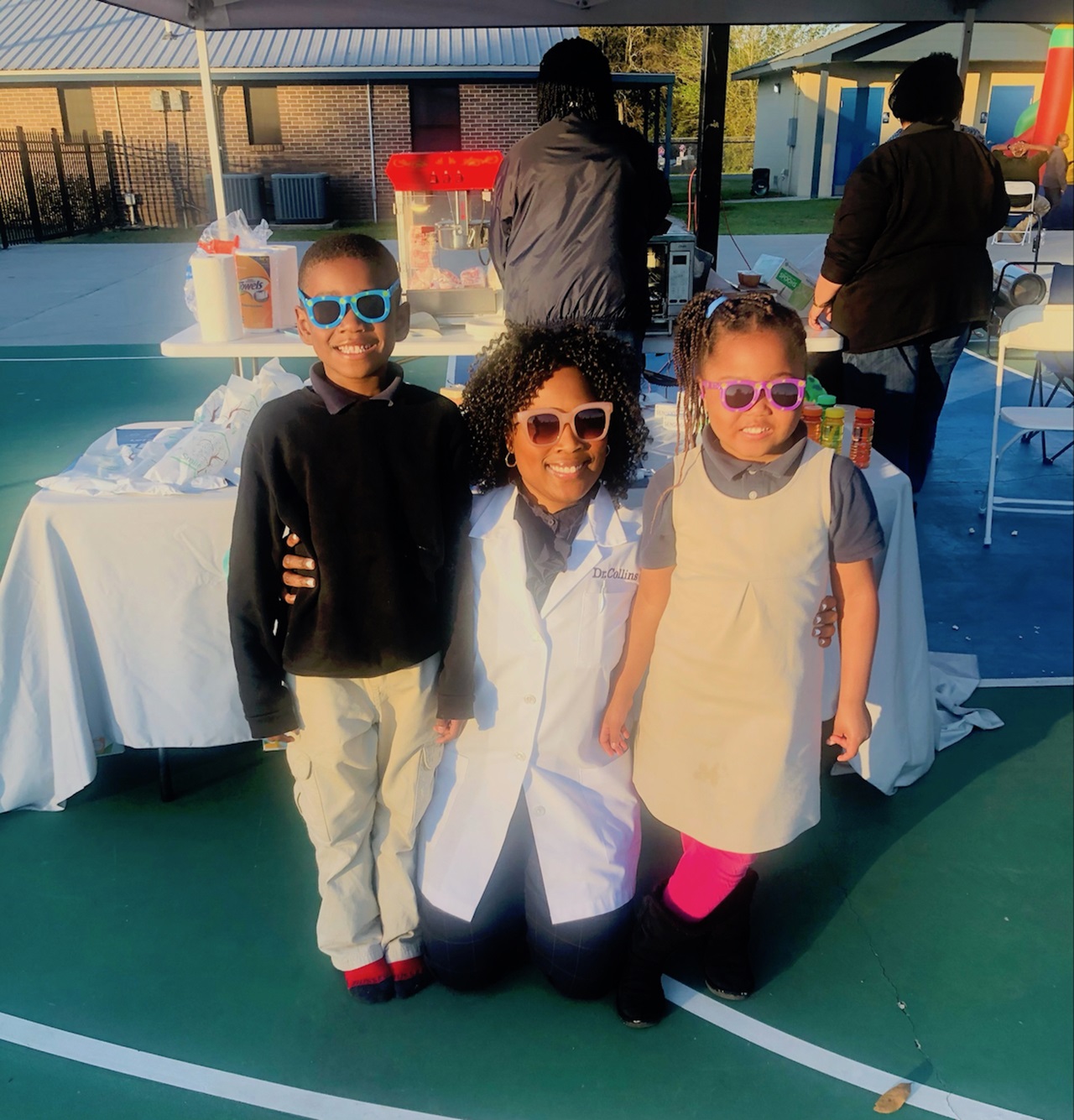 Photo of LaTedra M. Collins, D.D.S., with children at Children’s Dental Health Month event