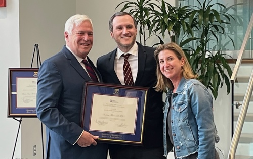 Photo of Dr. Fraser receiving alumni award