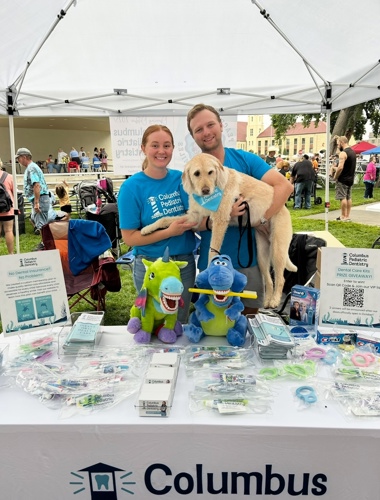 Photo of Dr. Harvey, husband and dog at